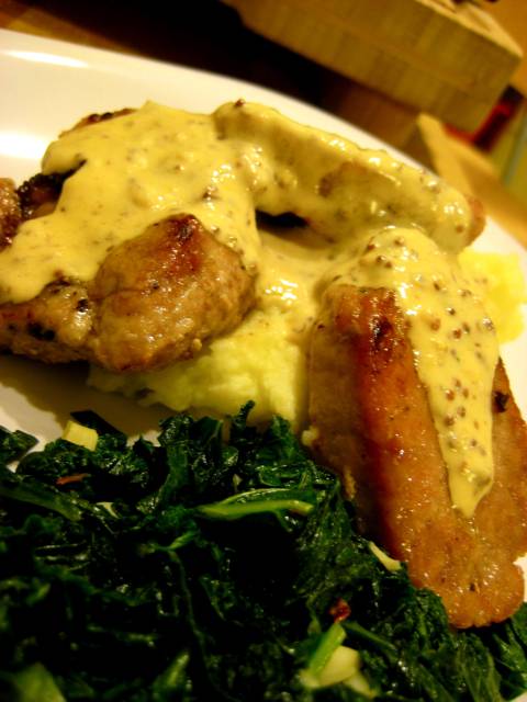 A hearty portion of pork loin with mustardy cream sauce and kale