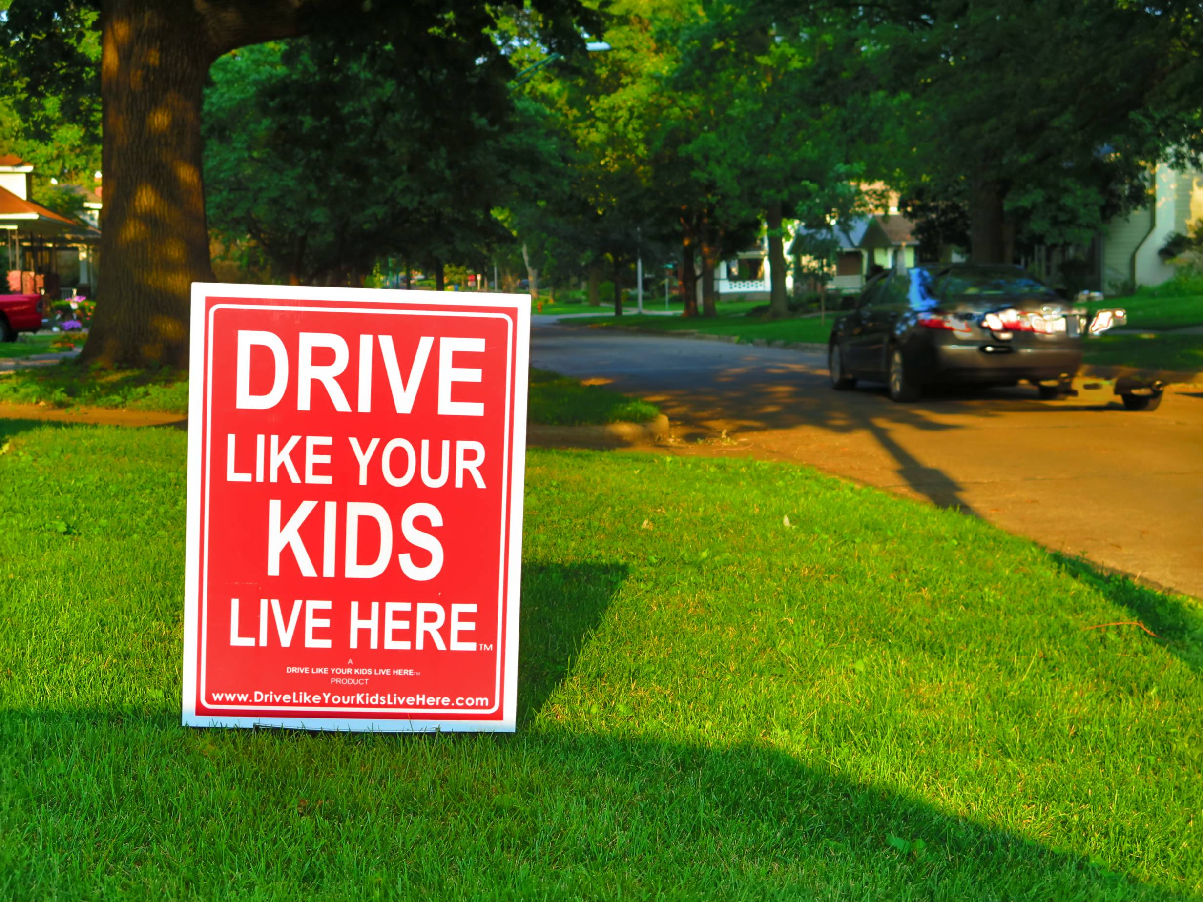 Drive like your kids live here sign