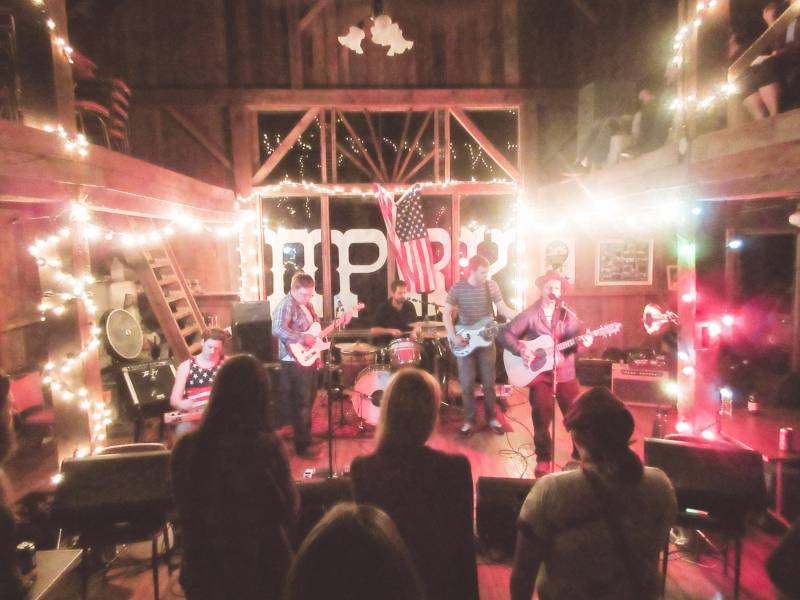 A concert happening inside a barn
