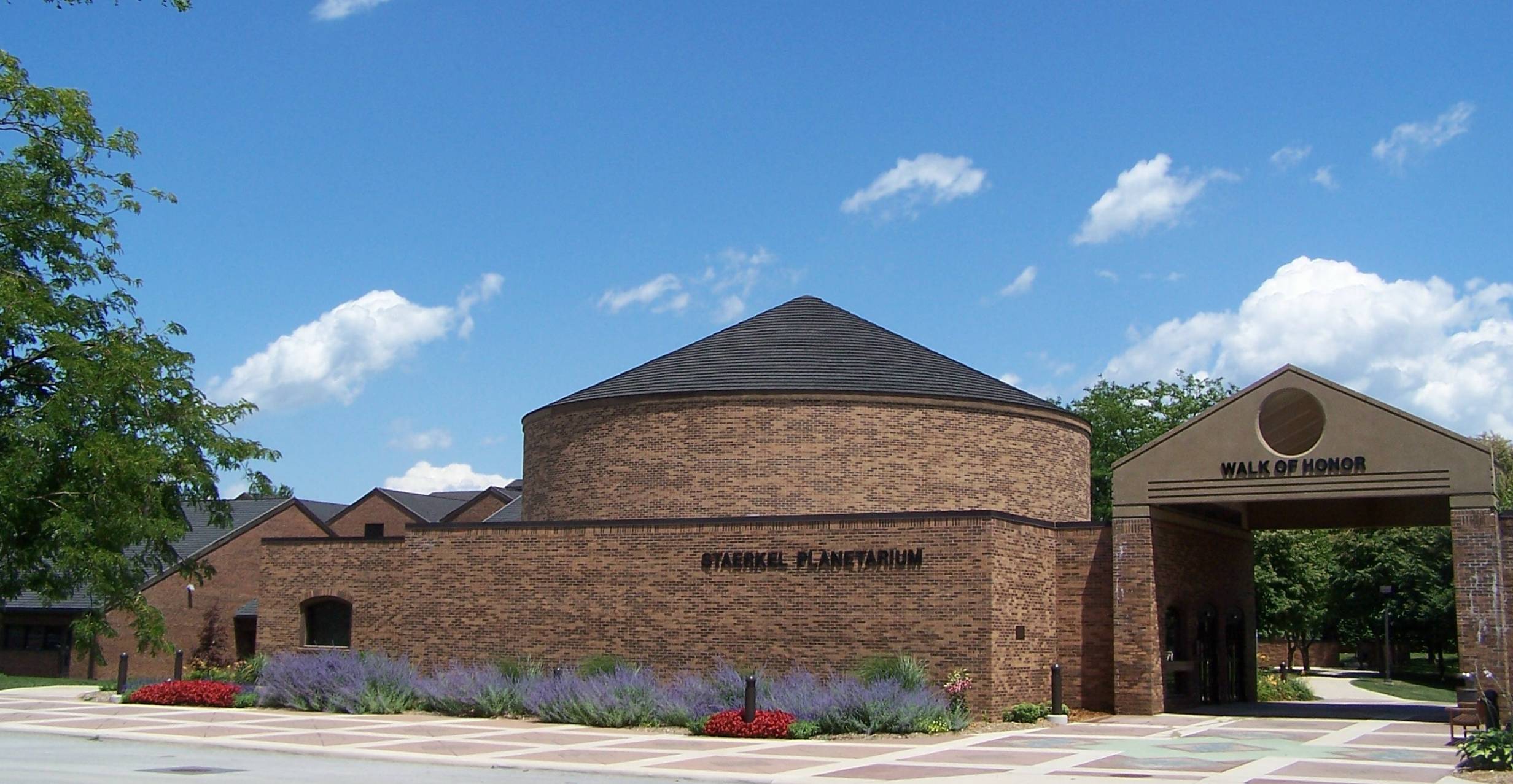 Exterior view of the Staerkel Planetarium at Parkland College. It's a brick building with a pitched dome roof.