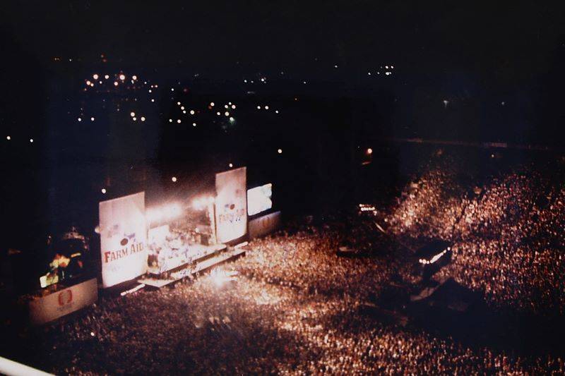 Aerial shot of the Farm Aid stage with crowd in 1985.