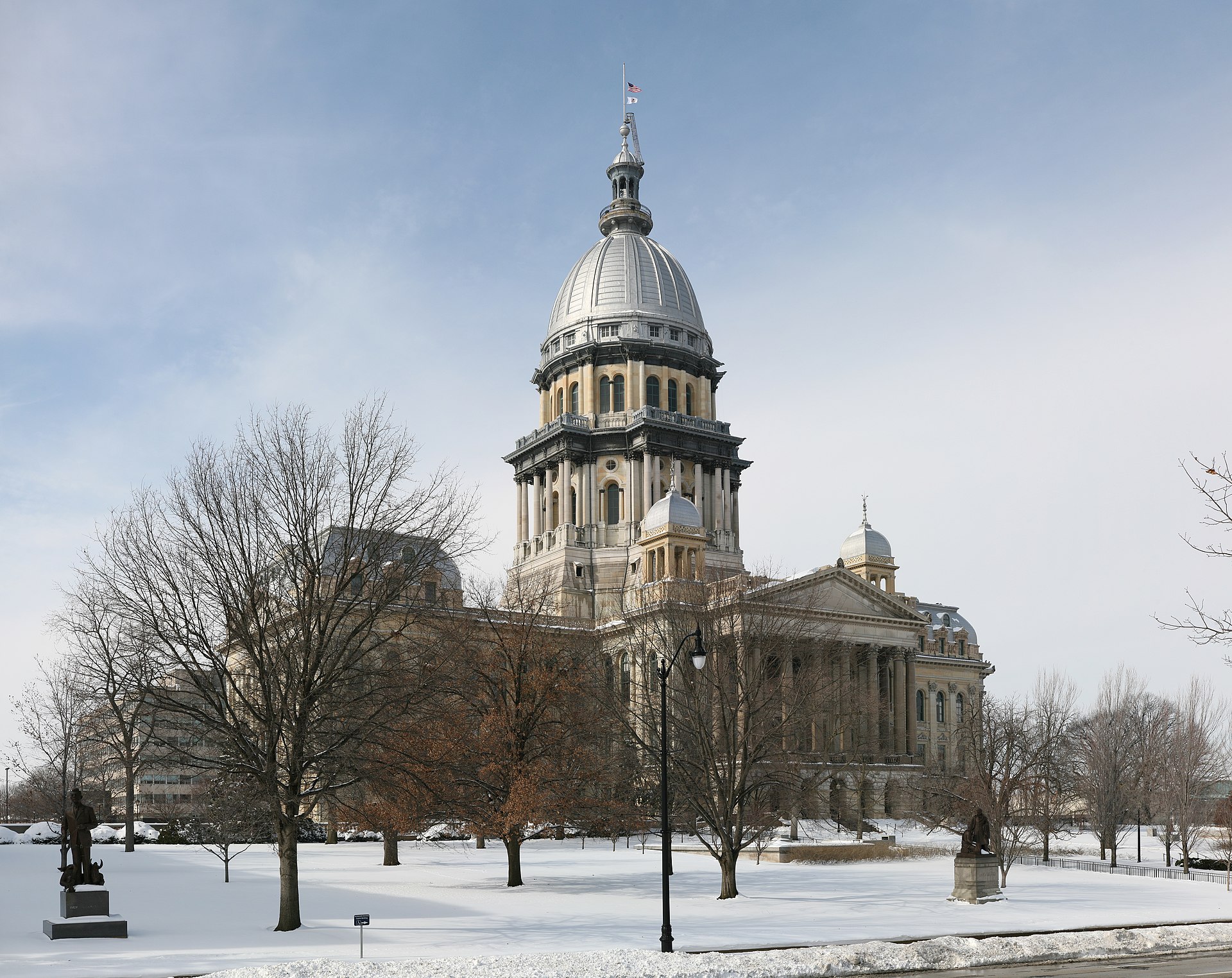 Illinois State Capitol building. It is winter, there is snow on the ground. The neoclassical revival building has a dome in the middle.