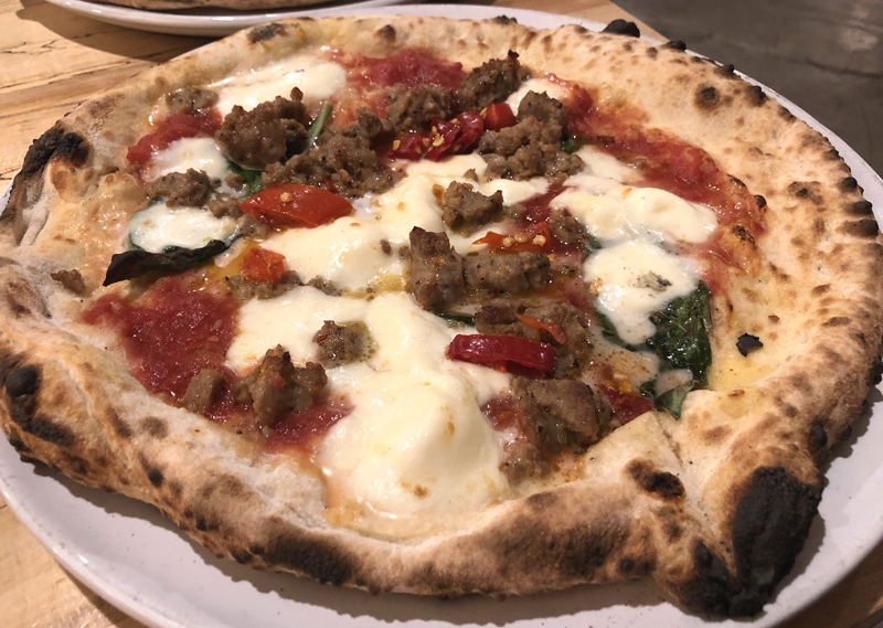 Neapolitan pizza with sausage, cheese, and tomato sauce from Pizzeria Antica in Champaign. Photo by Jessica Hammie. 