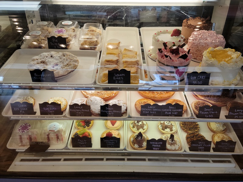 Various cakes, pies, and tarts on display in a case. Photo by Matthew Macomber.
