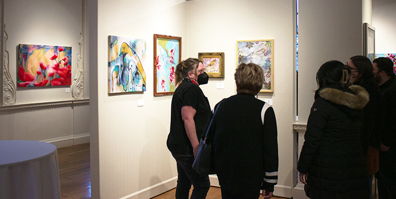Artist Shannon Percoco talks with guests at the opening reception.