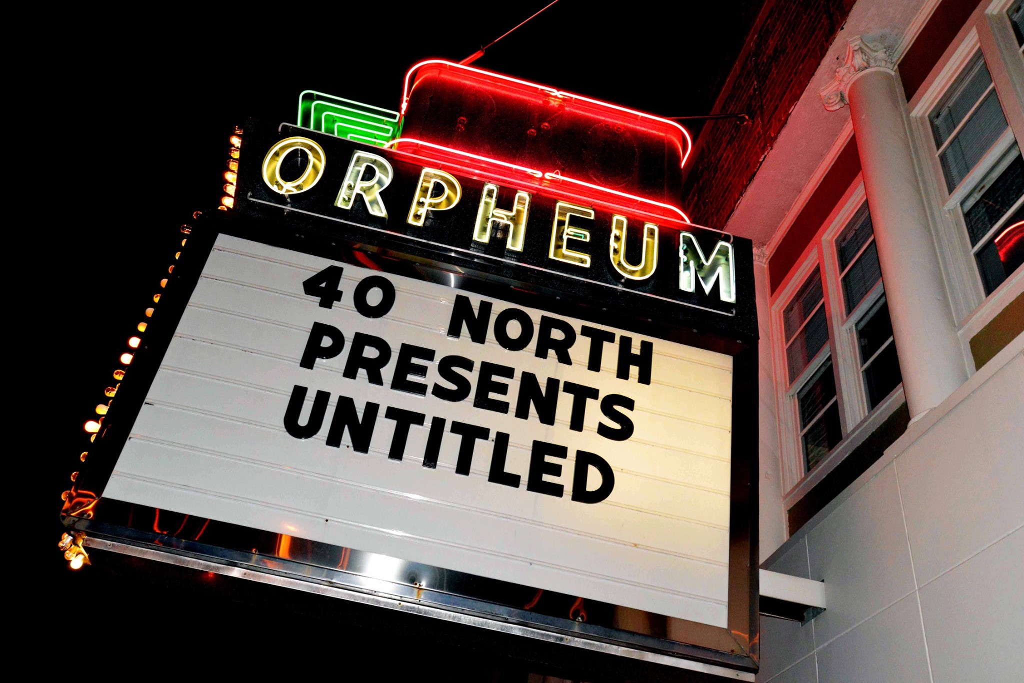 The sign outside the Orpheum Theater at night, with the neon accents lit up. The sign reads â€œ40 North Presents Untitled.â€ Photo from the 40 North Facebook page.