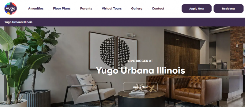 A screenshot from a website that says Yugo Urbana Illinois over a photo of a room with a coffee table surrounded by chairs, tall plants in the corner, and framed art on the wall. Screenshot from Gather website.