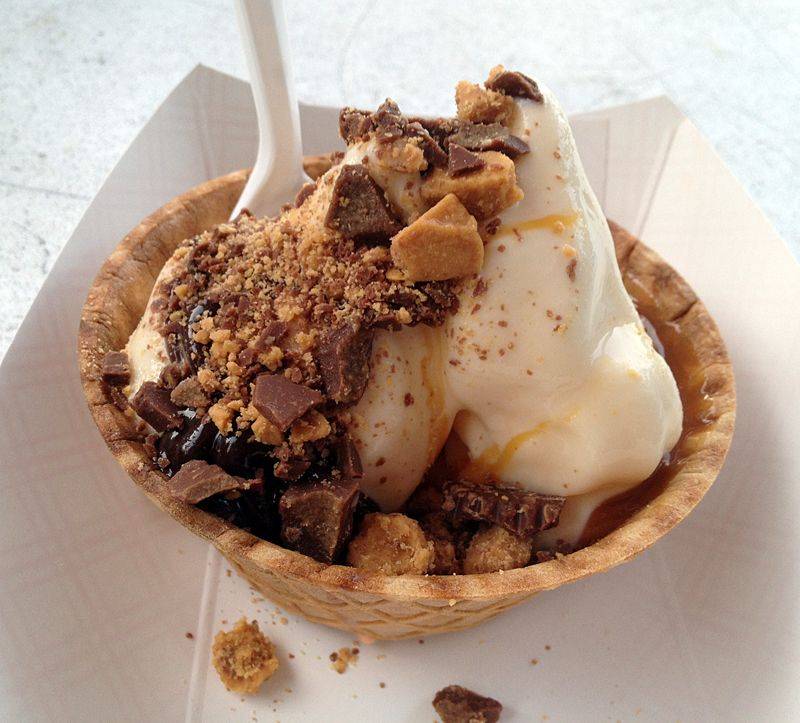 Sidney Dairy Barn ice cream in a waffle bowl with crushed peanuts and a white plastic spoon. Photo by Jessica Hammie.