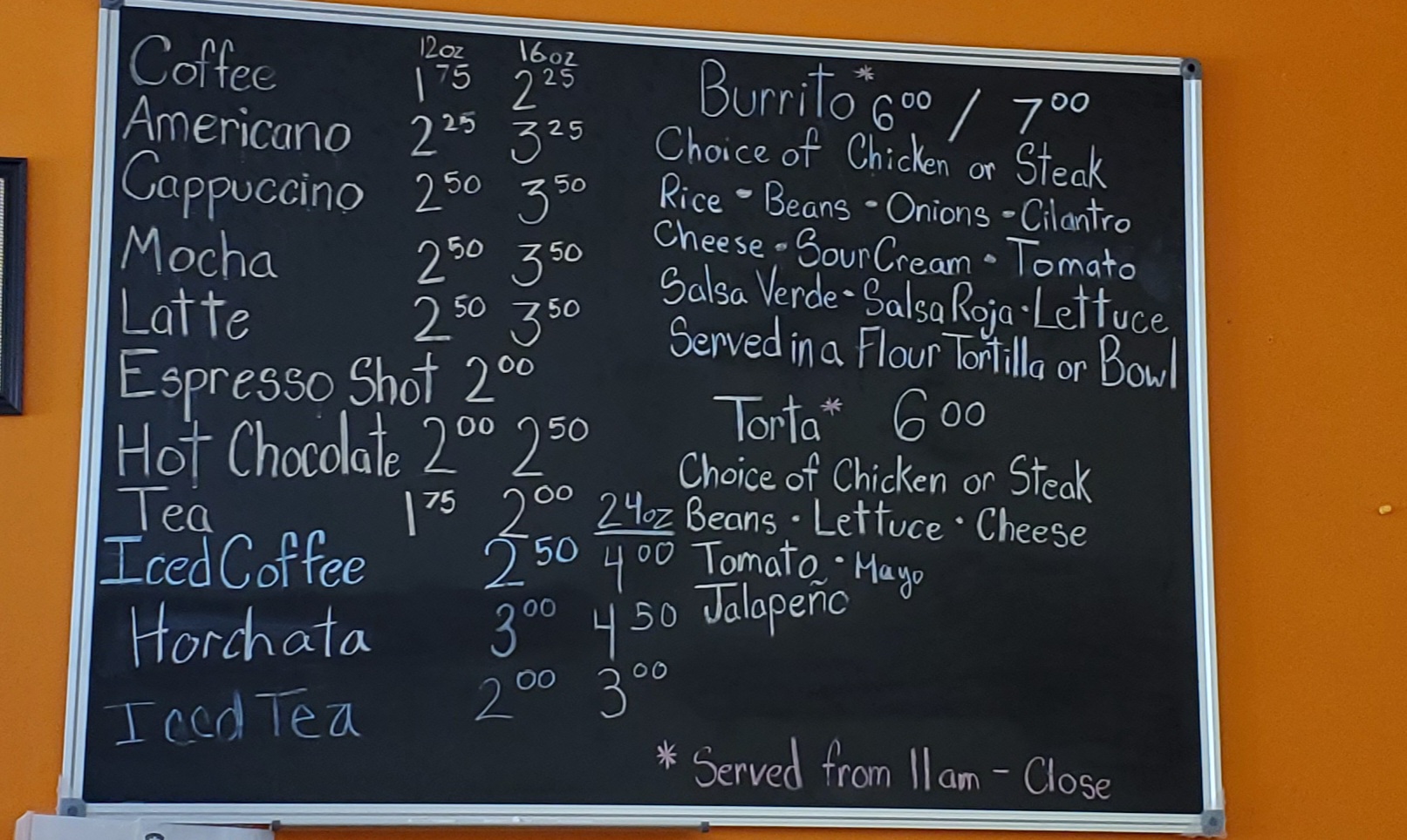 The handwritten menu at Rick's is on a black chalkboard hung on an orange wall. Photo by Carl Busch.