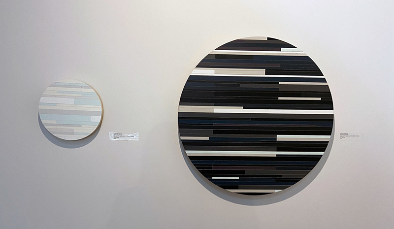 Wood circles by Nathan Westerman on the wall at Gallerie 112.