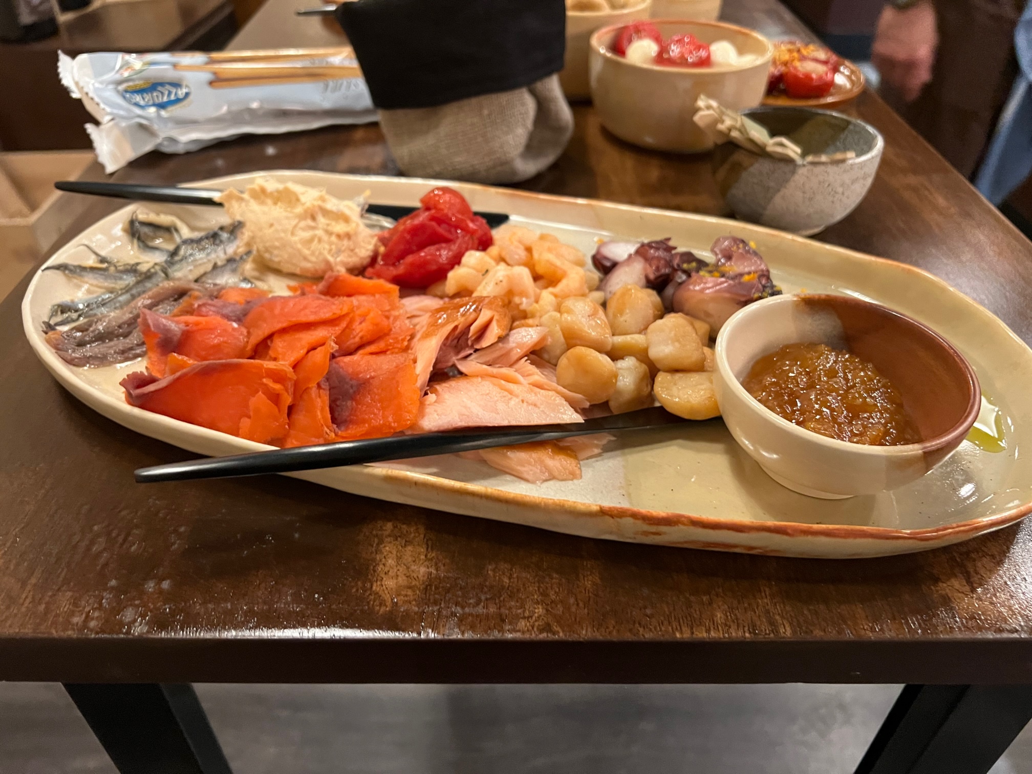On a handmade platter, there is a selection of smoked seafood. Photo by Alyssa Buckley.