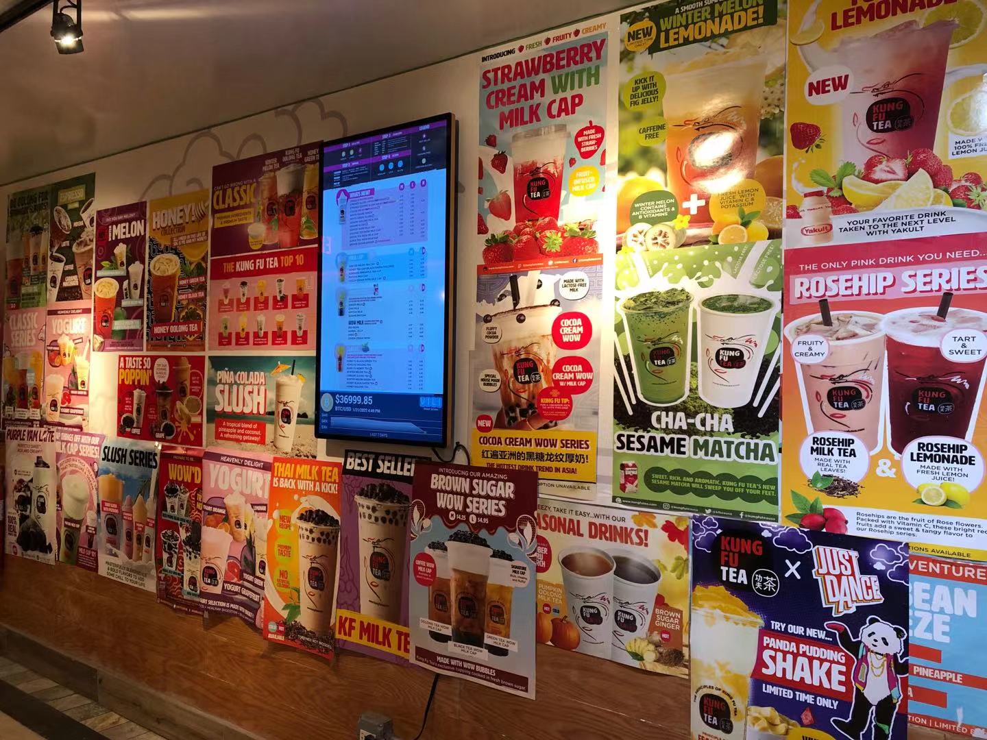 Inside Kung Fu Tea in Champaign, Illinois, there are boba tea posters and a black flat touch-screen in the center. Photo by Xiaohui Zhang.