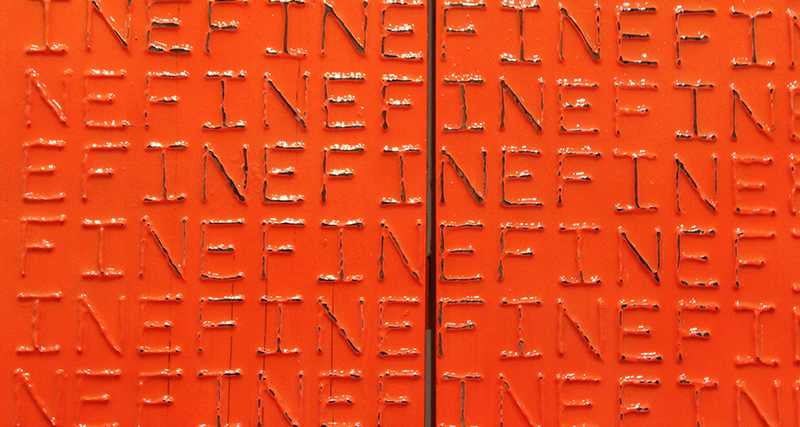 Close up of orange section of sculpture with the word 