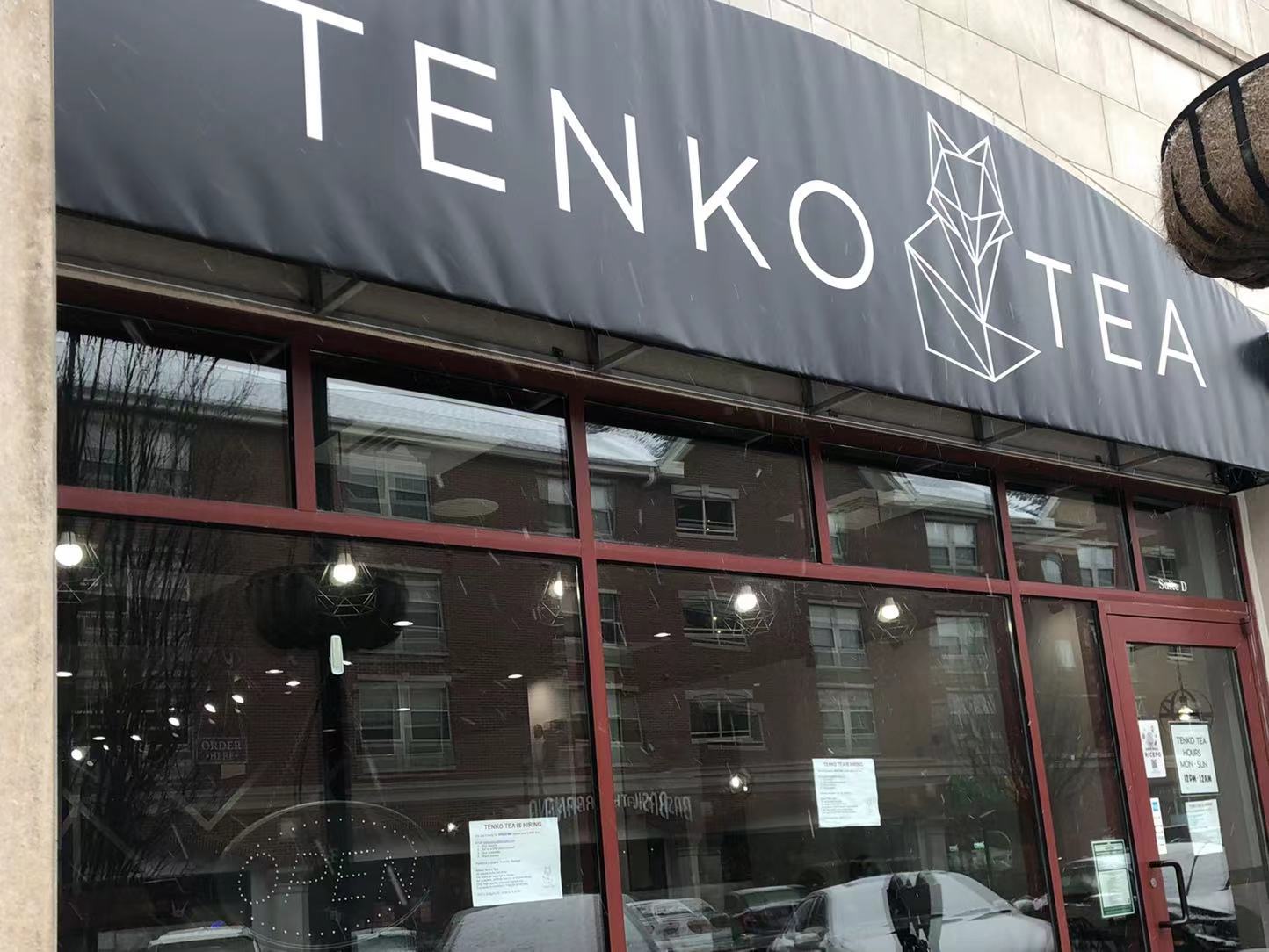 The exterior of Tenko Tea has a black awning with the boba shop's name in a thin font with a fox. Photo by Xiaohui Zhang.