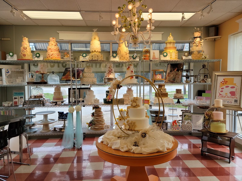 Dozens of display-only cakes from competitions arranged on shelves along the bakery walls. Photo by Matthew Macomber.