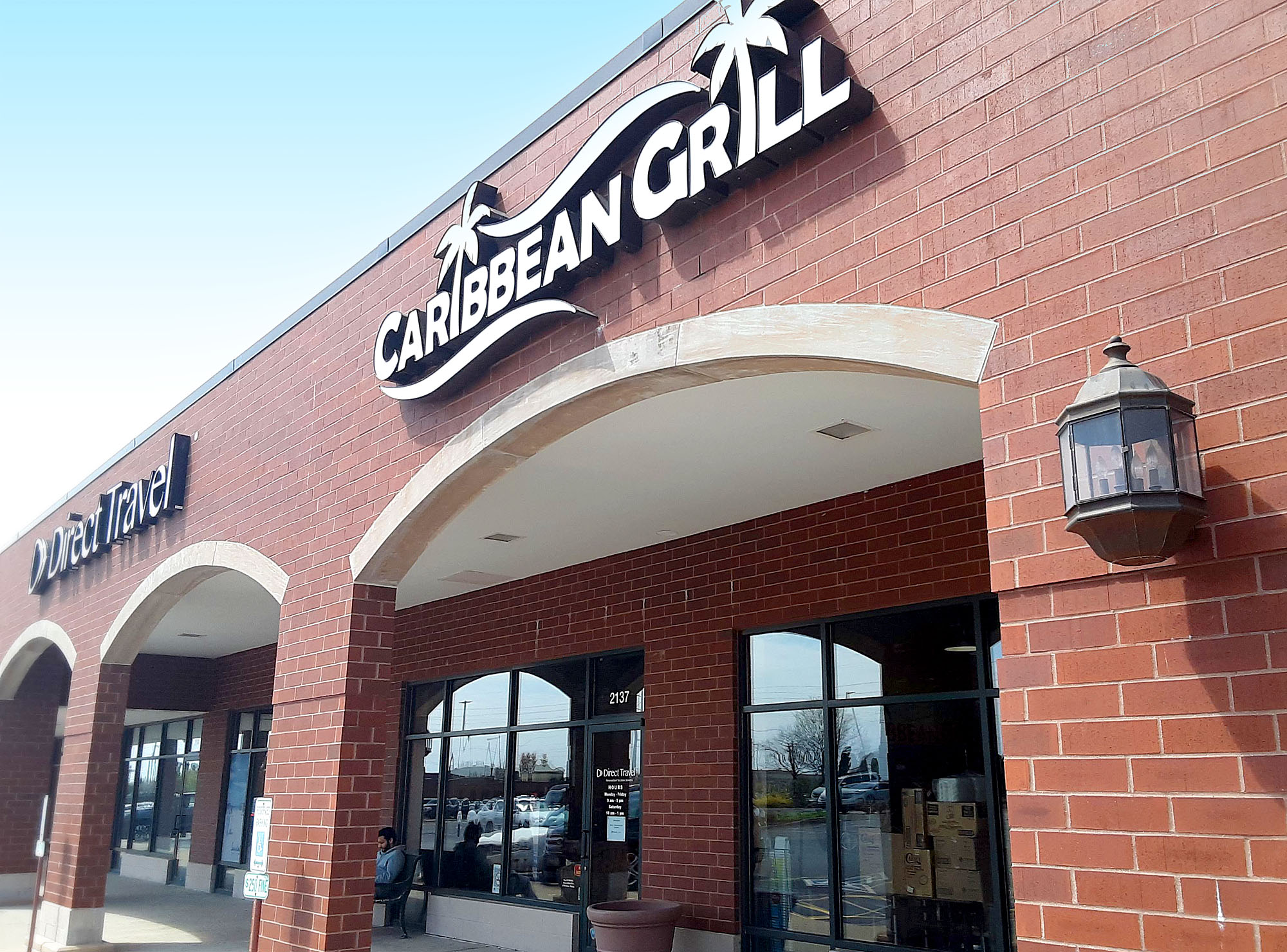 Outside of Caribbean Grill, there is a giant sign above the restaurant in Champaign. Photo by Paul Young.