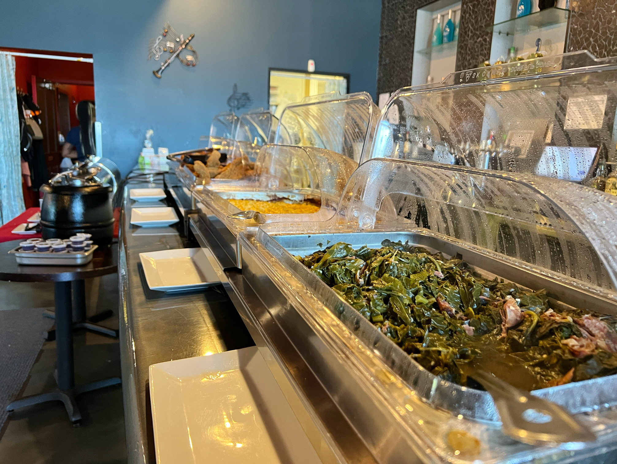 On the buffet line, there are lots of side dishes in hot silver pans with open plastic covers. Photo by Alyssa Buckley.