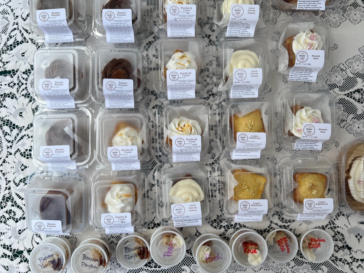 On a lacy tablecloth, there are mini cakes for sale at the market. Photo by Alyssa Buckley.