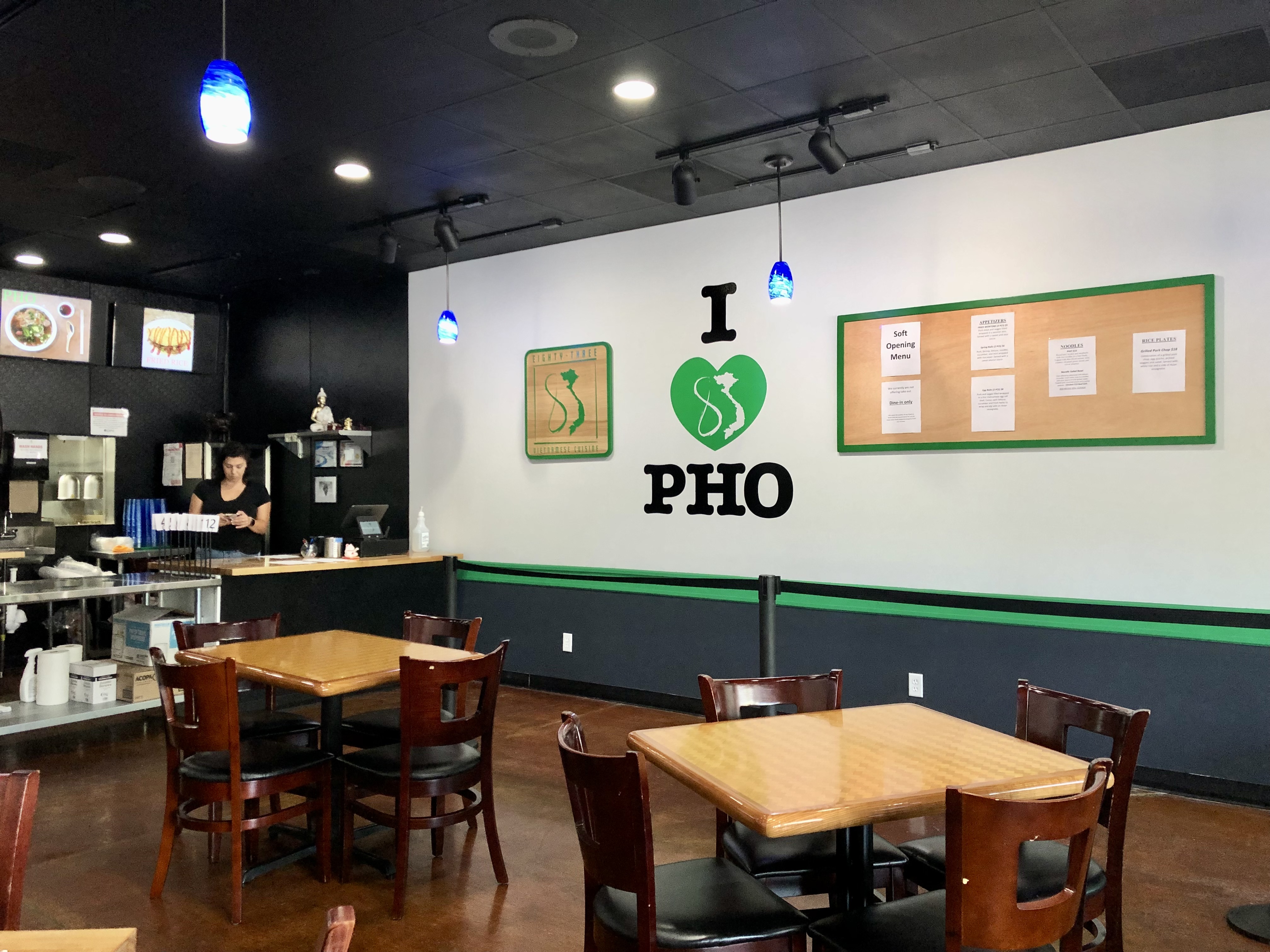 Inside 83 Vietnamese Cuisine, there is a white wall with 