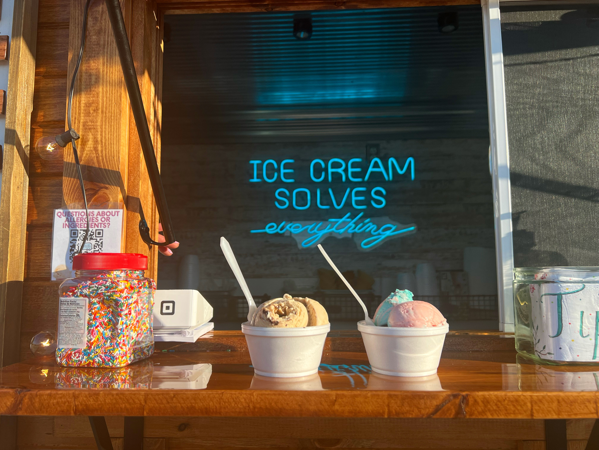 Two cups of ice cream sit on a wooden ledge on the ice cream truck Main Street Creamery. Photo by Alyssa Buckley.