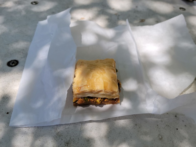 A square of baklava on a broken open wax paper bag. Photo by Matthew Macomber.