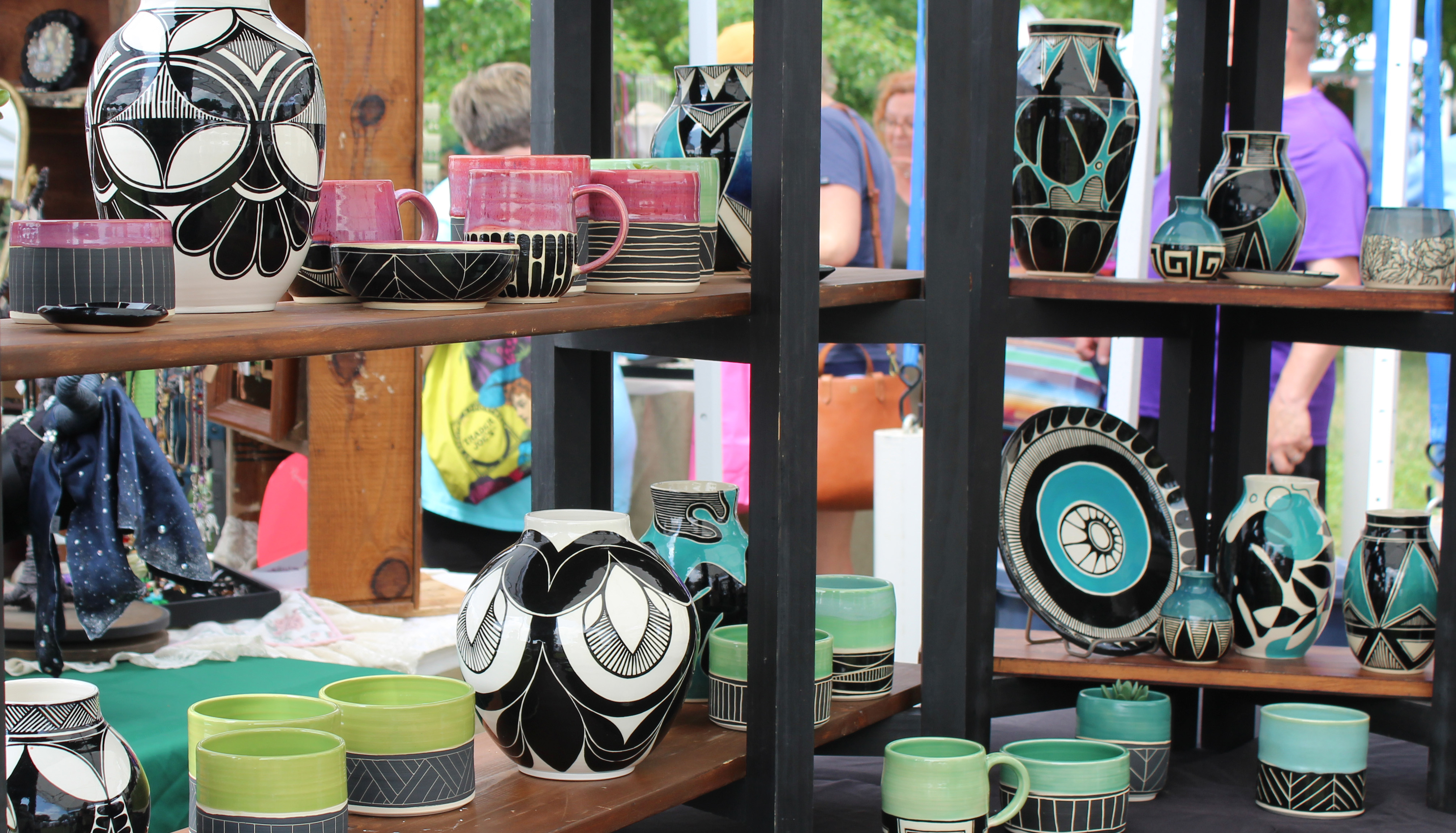 A display of ceramics with rich hued glazes and bold geometric designs.