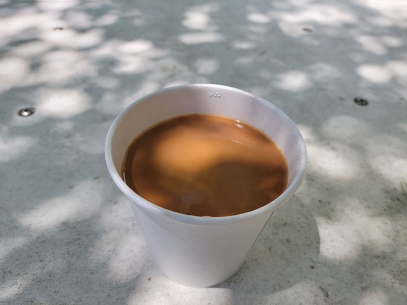 A paper cup of hot chai karak. Photo by Matthew Macomber.