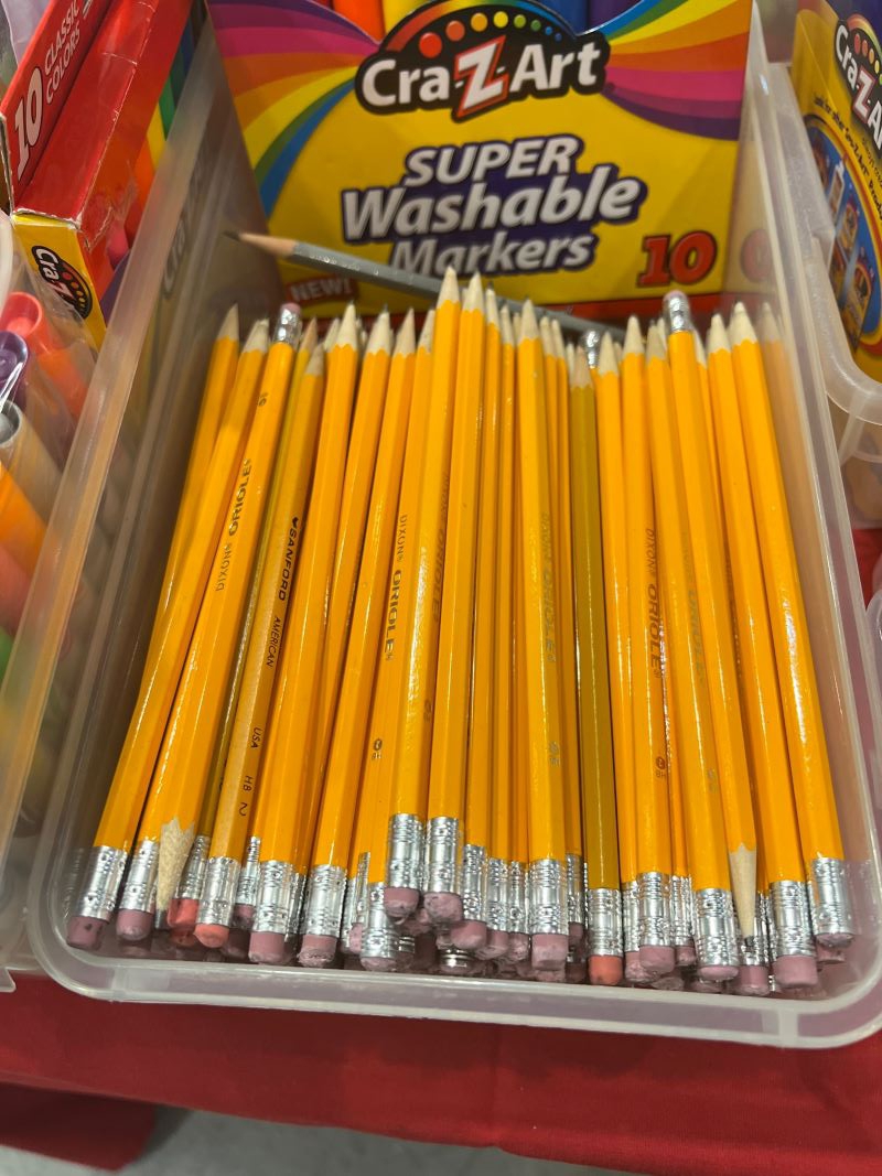 A plastic bin filled with sharpened yellow number two pencils. Photo by Julie McClure.