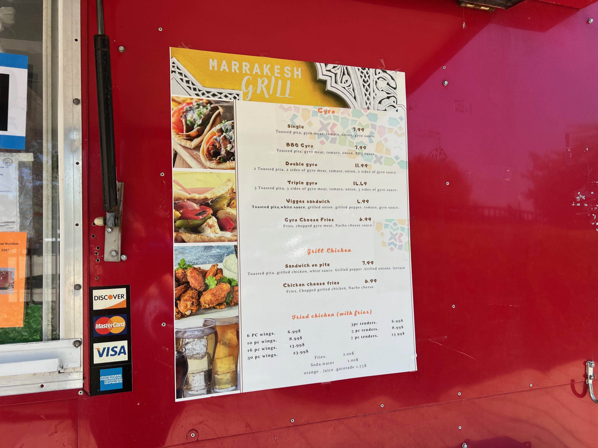 The white menu is posted on the red food truck. Photo by Alyssa Buckley.
