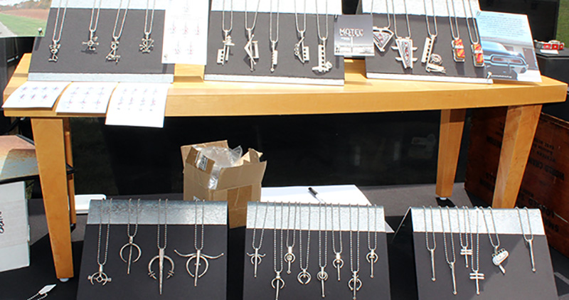 Shelves of handmade metal jewelry made from reclaimed parts in a variety of shapes and designs.