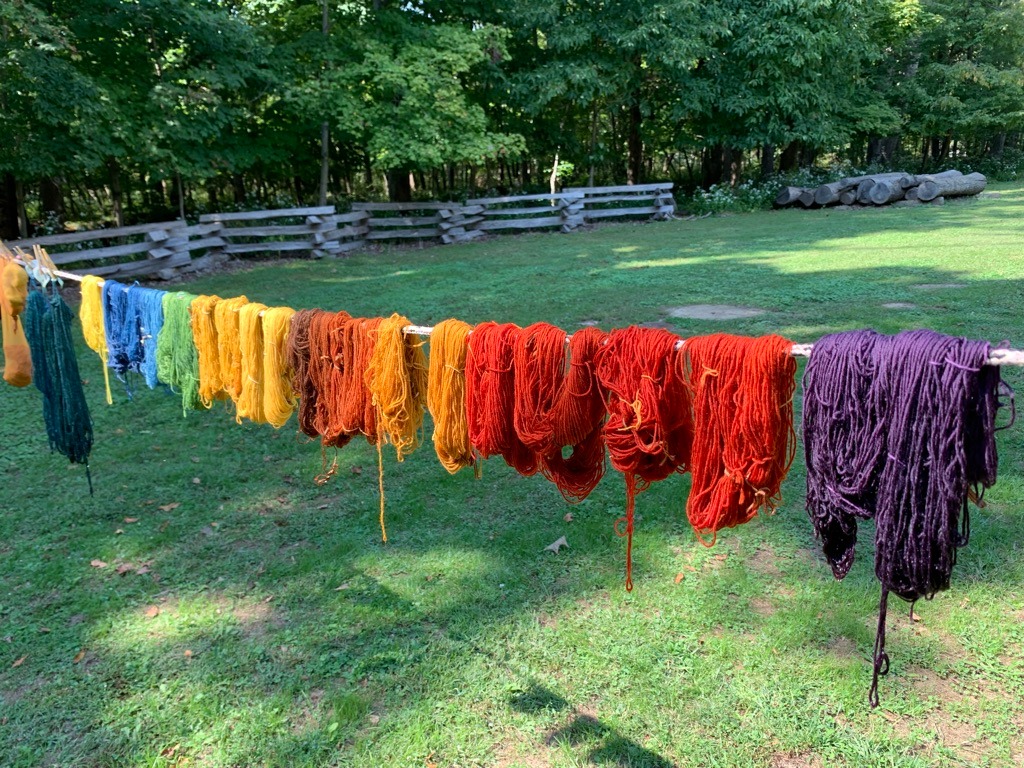 Different colored fibers are hung to dry on a clothesline. Together, they create a rainbow of colors. Photo from the Facebook event page.