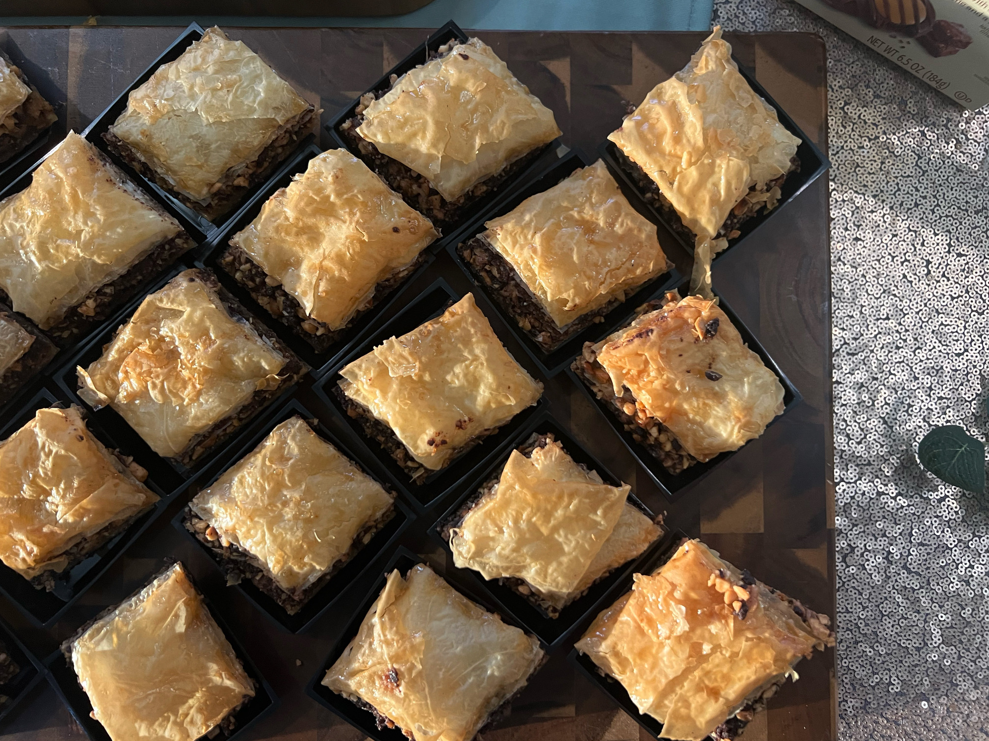 On a black tray, squares of baklava made by Lodgic's Everyday Kitchen are arranged for tasting. Photo by Alyssa Buckley.