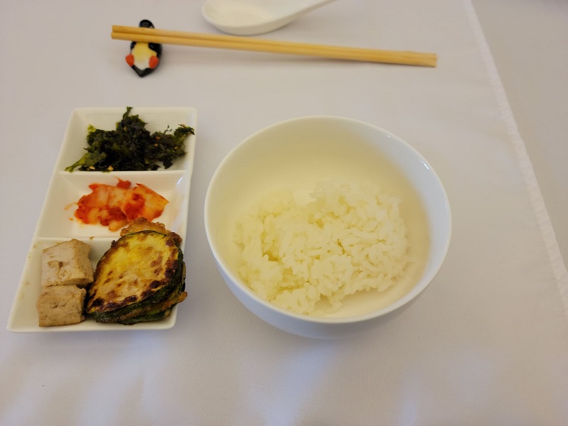 Bansang where white rice is in a small bowl and a small, three compartment tray contains the seaweed, kimchi, and tofu/fried vegetables slices. Photo by Matthew Macomber.