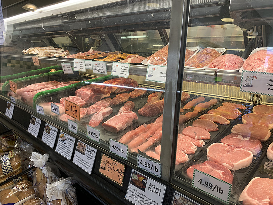 Inside Old Time Meat & Deli, there is a cooler of uncooked meats for sale by the pound. Photo by Zoe Valentine.