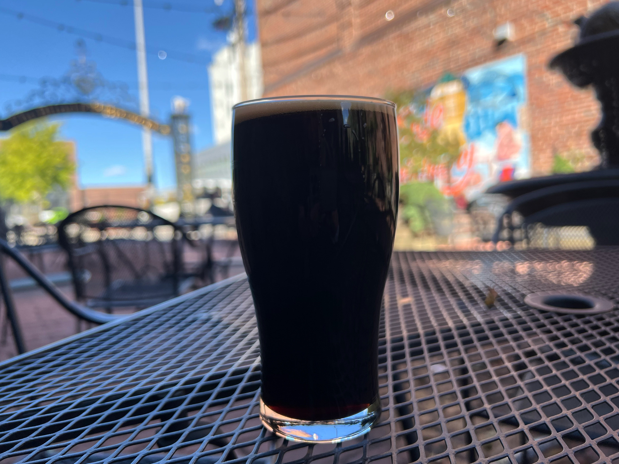 On a black patio table at Blind Pig in Champaign, there is a draft pour of Columbia Street Coffee Stout. Photo by Alyssa Buckley.