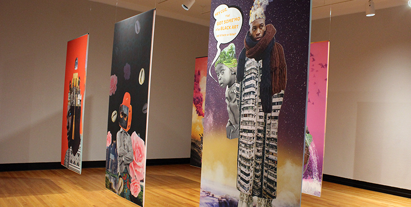 Afrofuturistic digital collages printed on banners hanging in a museum gallery.