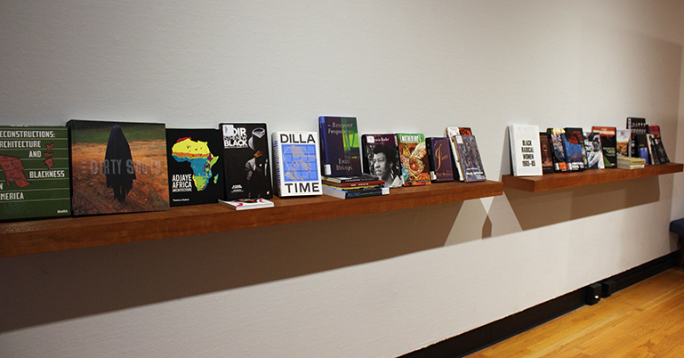 A shelf of books on Afrofuturism and Black art and identity on display in BLACKMAU's installation.