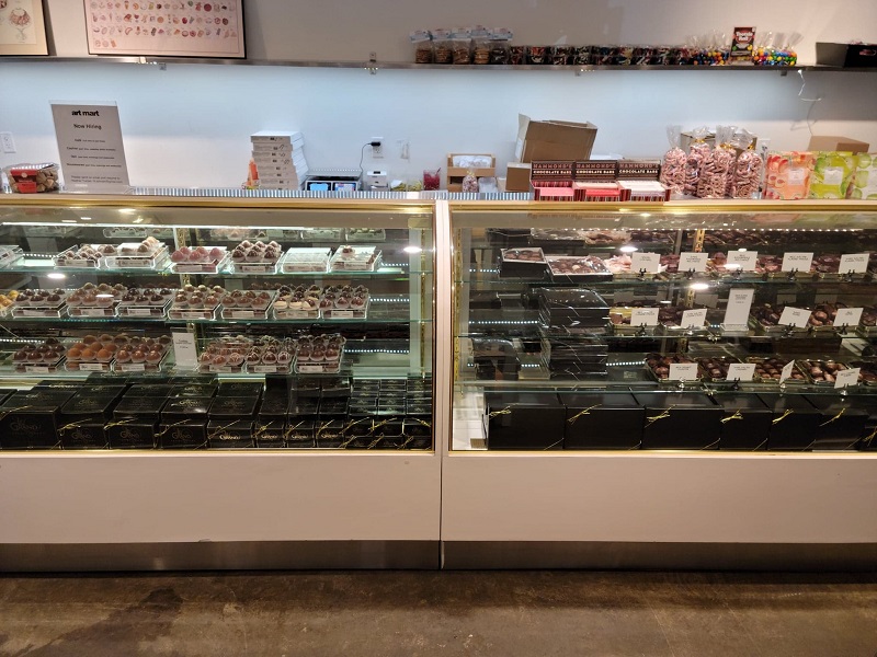 The chocolates display with dozens of small and prepacked boxes behind the glass. Photo by Matthew Macomber.