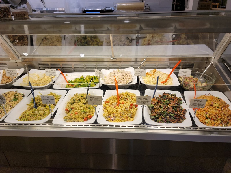 A dozen different Art Mart salads on display. Photo by Matthew Macomber.