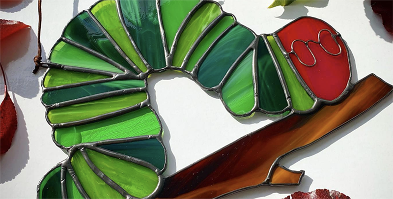 A caterpillar shaped glass ornament. Photo from Glassology's Instagram.