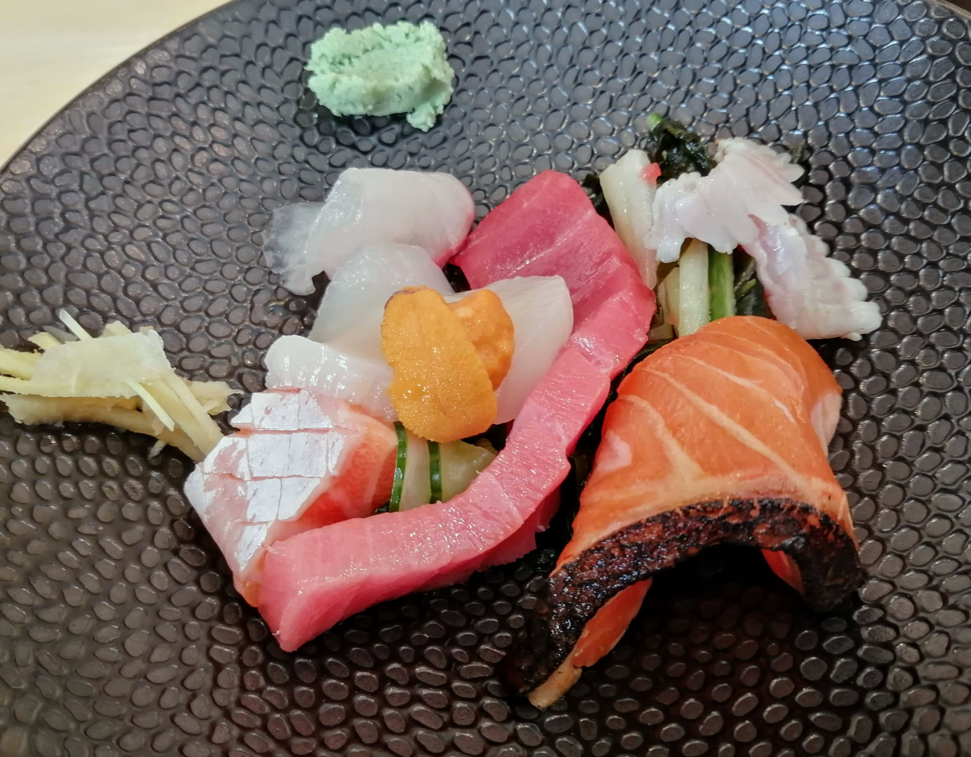 A close-up of a colorful sashimi plate with a variety of raw seafood. Photo by Paul Young.