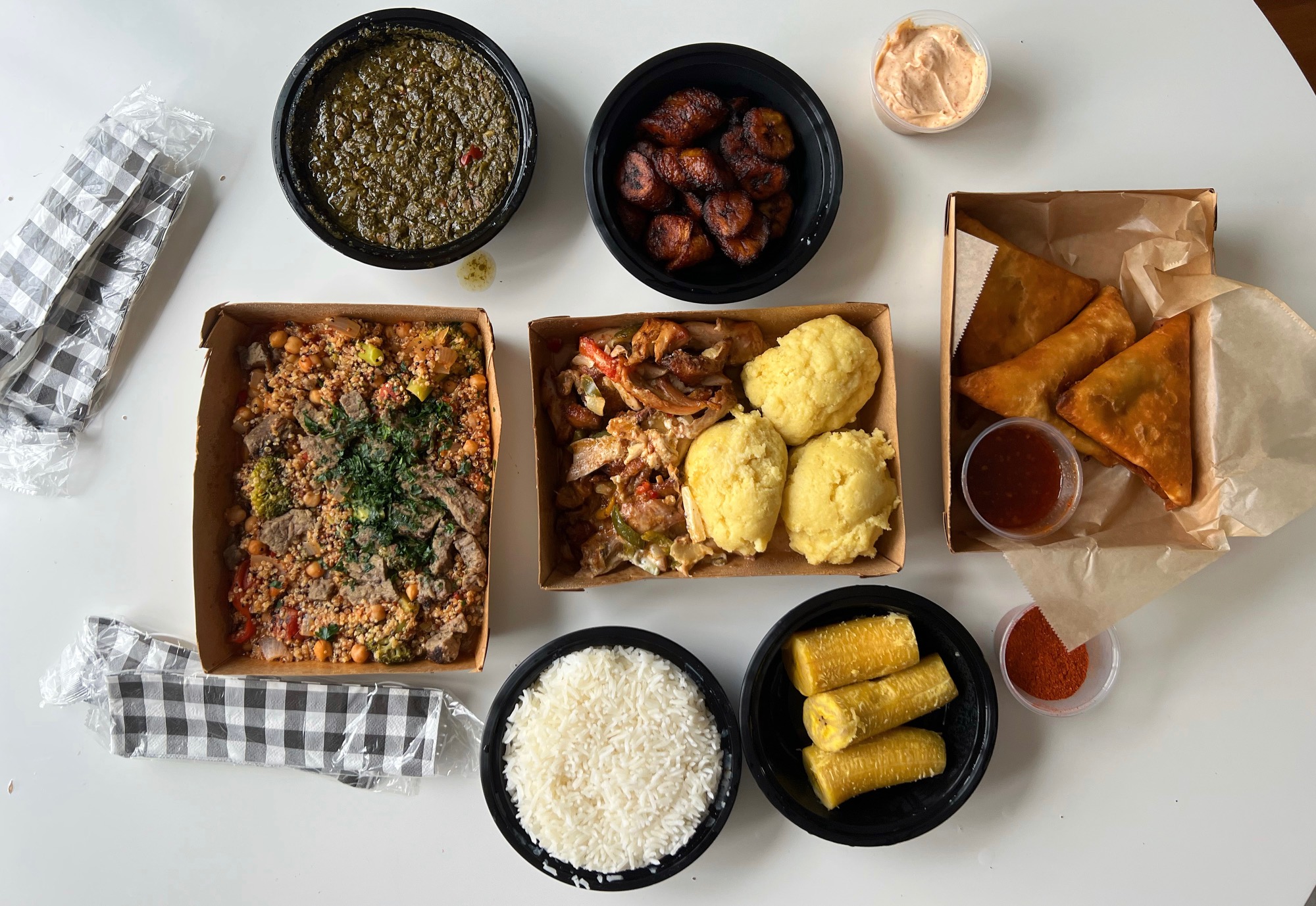 An overhead photo shows the author's meal from Mama Meta's Canteen, many Congolese comfort foods. Photo by Alyssa Buckley.