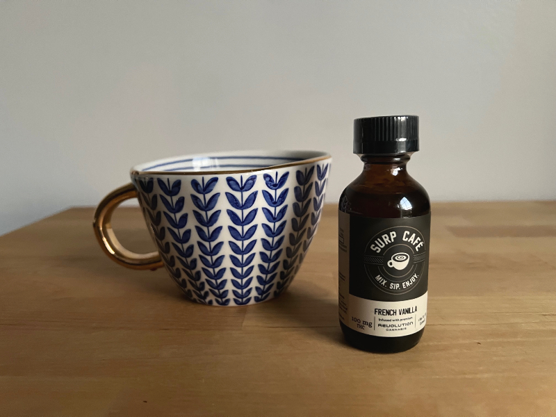 On a butcher block counter, there is a mug beside Revolution Cannabis' French vanilla surp edible. Photo by Alyssa Buckley.