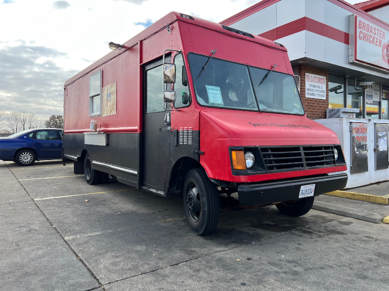 The exterior of Garro's Taste of the City, a red food truck, parked at the Shell Station in Urbana. Photo by Alyssa Buckley.