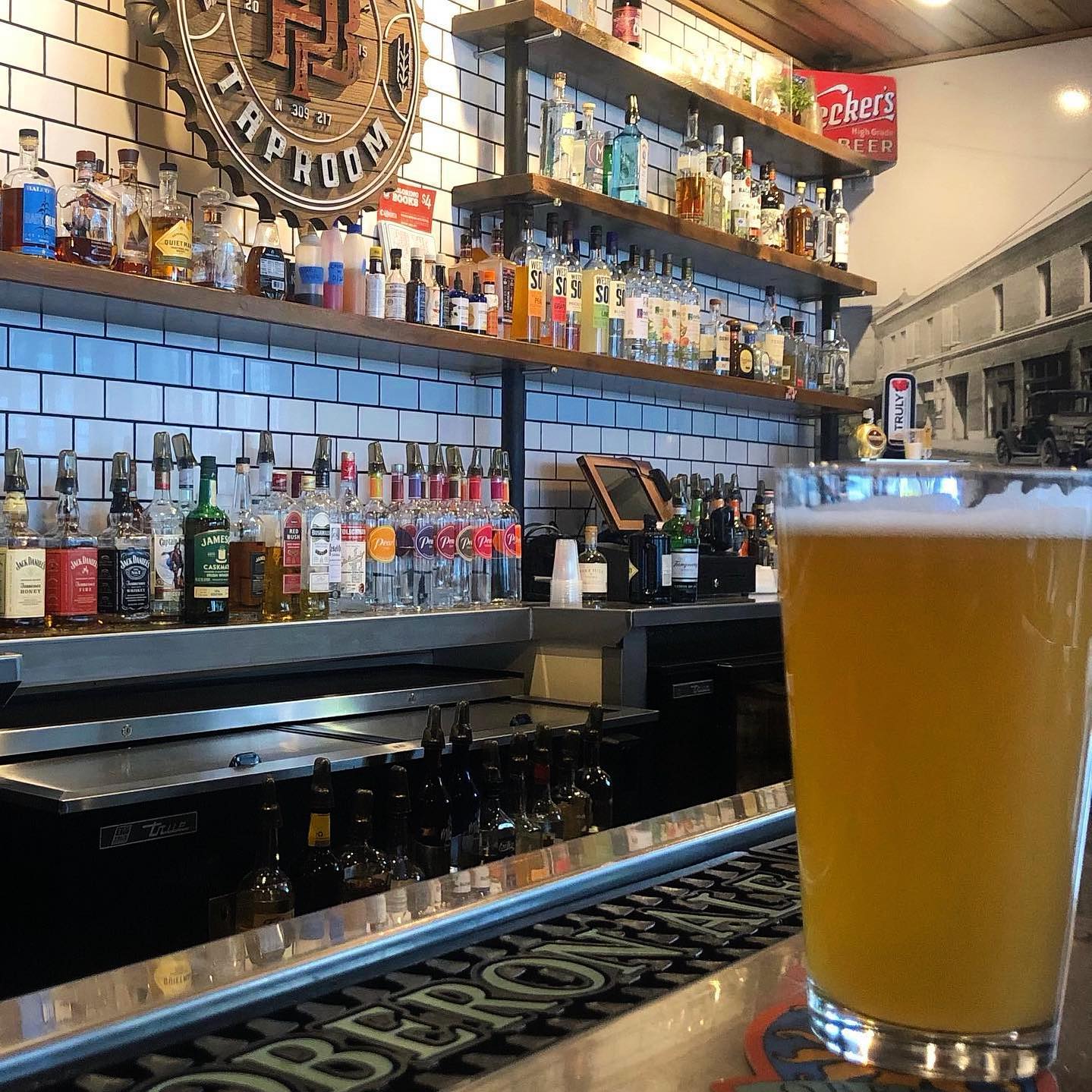 Inside Pour Bros in Downtown Champaign, a draft beer is in a glass on the bar. Photo from Pour Brosâ€™s Facebook page.
