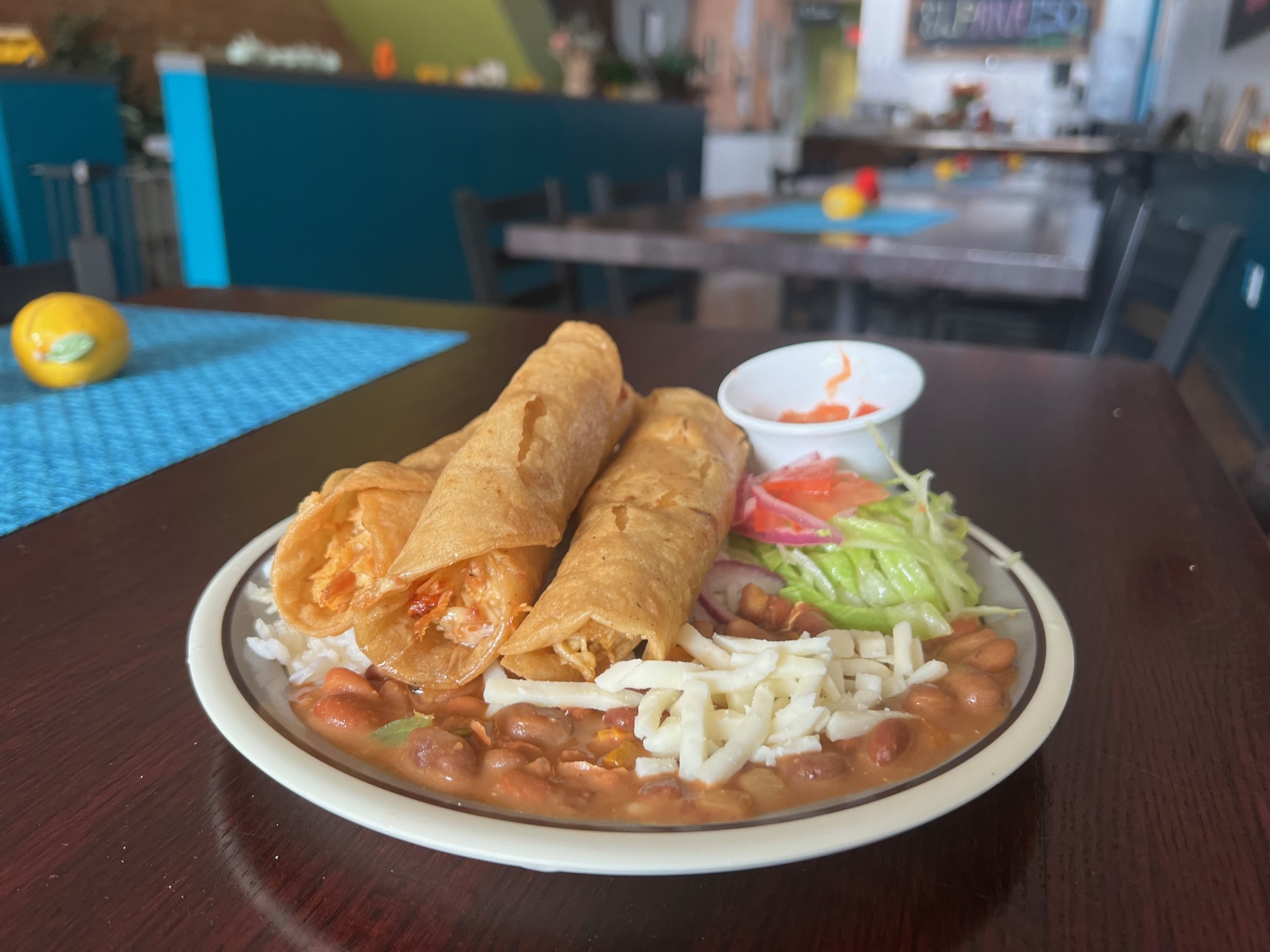 A plate of three flautas sits on a white plate at El Paraiso. Photo by Alyssa Buckley.