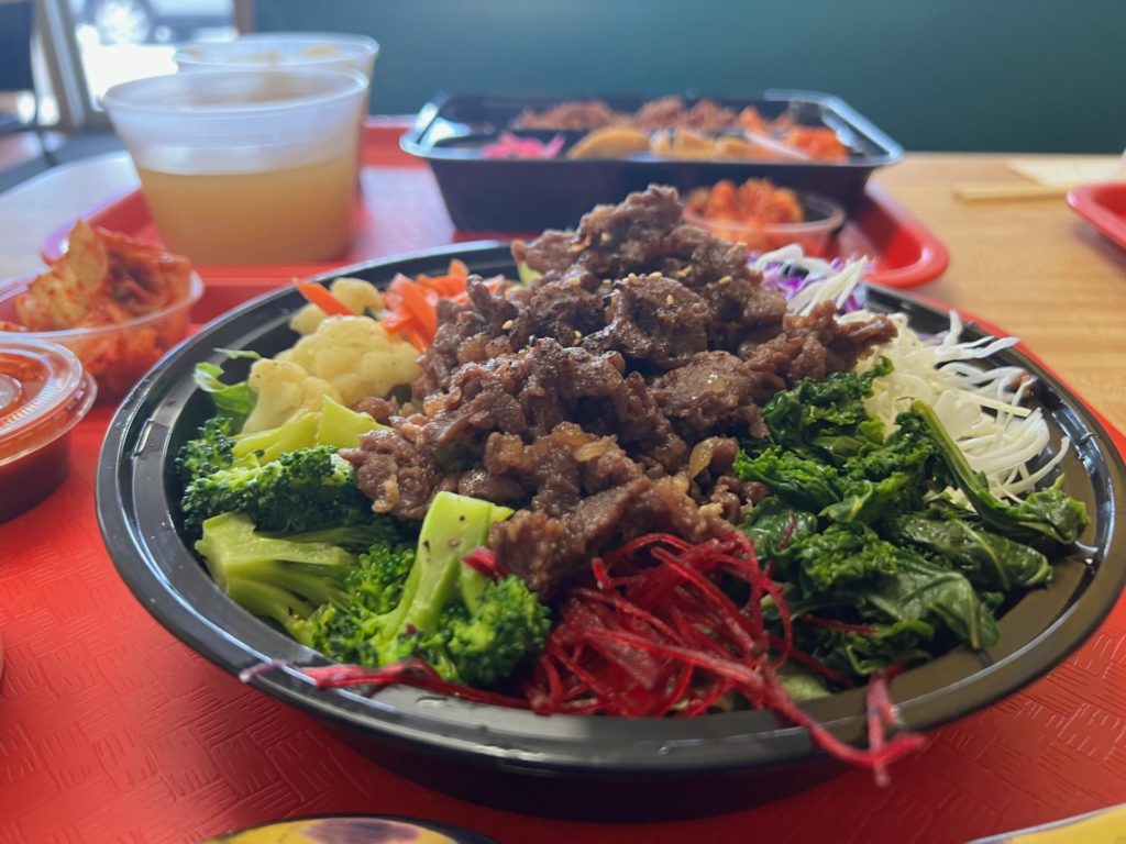 In a black plastic bowl there is a beef bulgogi dish from Kimchi Factory. Photo by Alyssa Buckley.