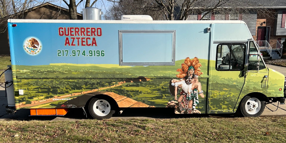 Guerreo Azteca Taco Truck is closed and parked at the curb in a residential area in Champaign, Illinois. Photo from Guerrero Azteca's Facebook page.