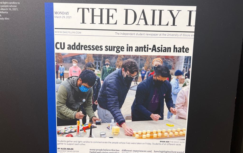 A museum panel with an images of the front page of the Daily Illini, which features a photo of students lighting candles under the headline CU addresses surge in anti-Asian hate.