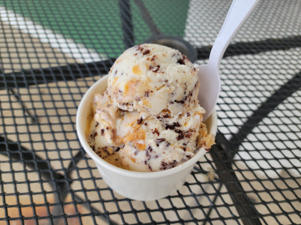 A cup of peanut butter cookie dough ice cream outside of Grovestone on the metal tables. Photo by Matthew Macomber.